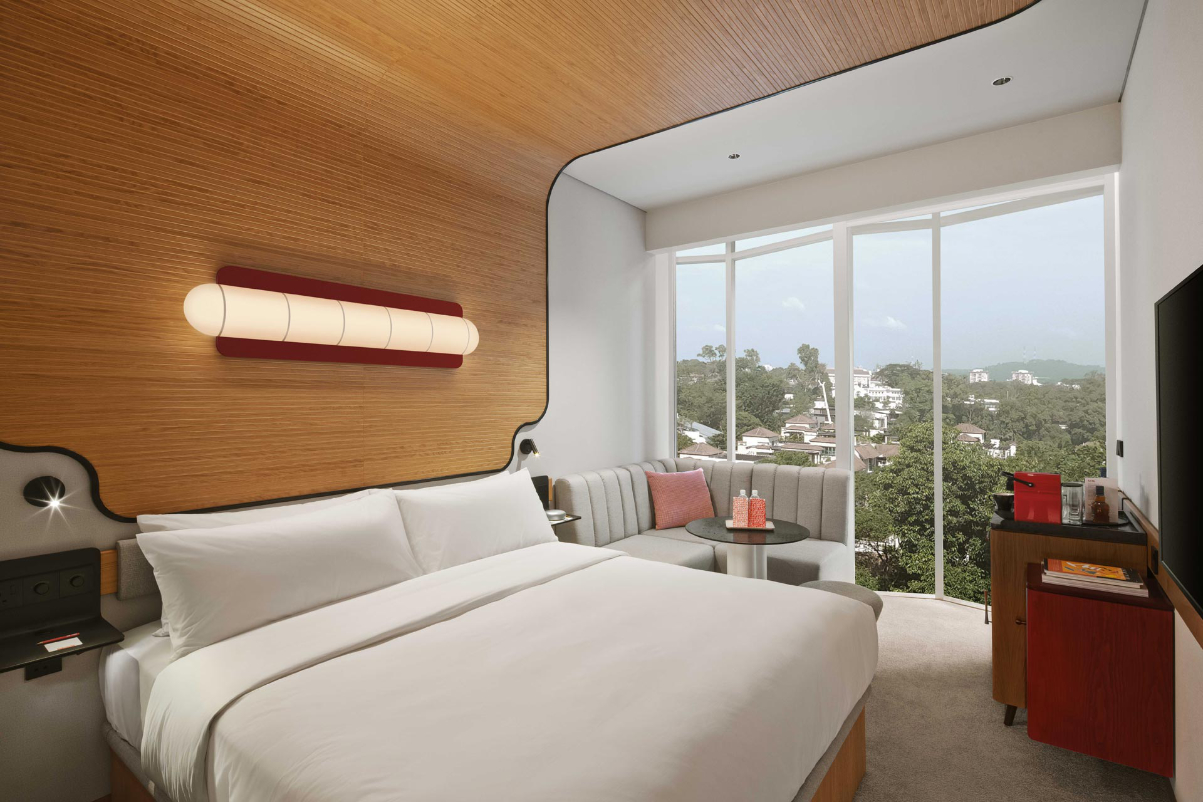 a boutique hotel room with a view out the window of hills in Singapore