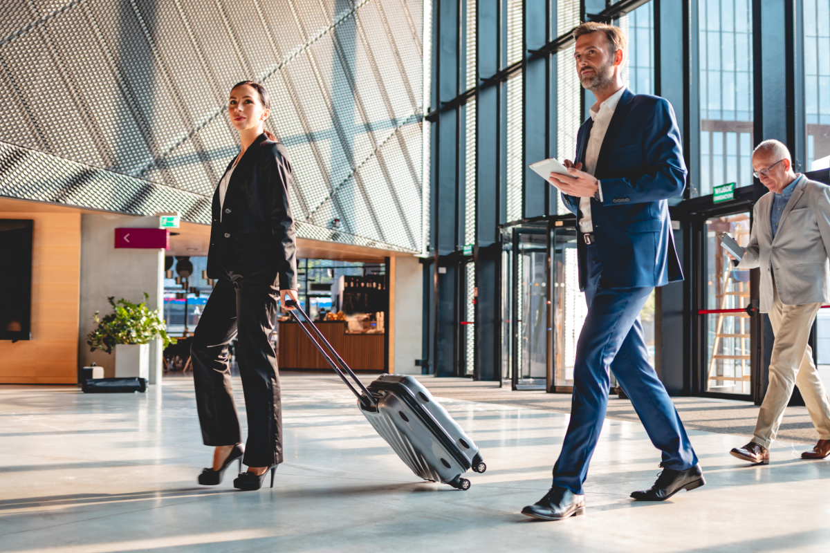 people entering an airport dressed in business attire